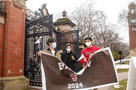 Masked students walk through the Van Wickle Gates