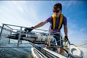 Michael Demanche working on a boat