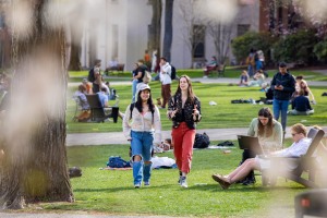 students gather and walk on the College Green