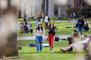 two students walk and talk on the College Green