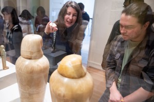 people look at artifacts in a case