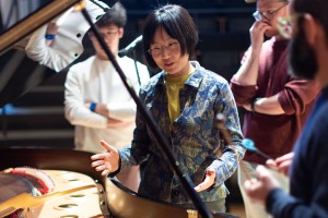 Wang Lu works with student musicians