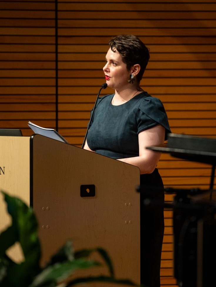 Amanda Strauss speaking at a podium