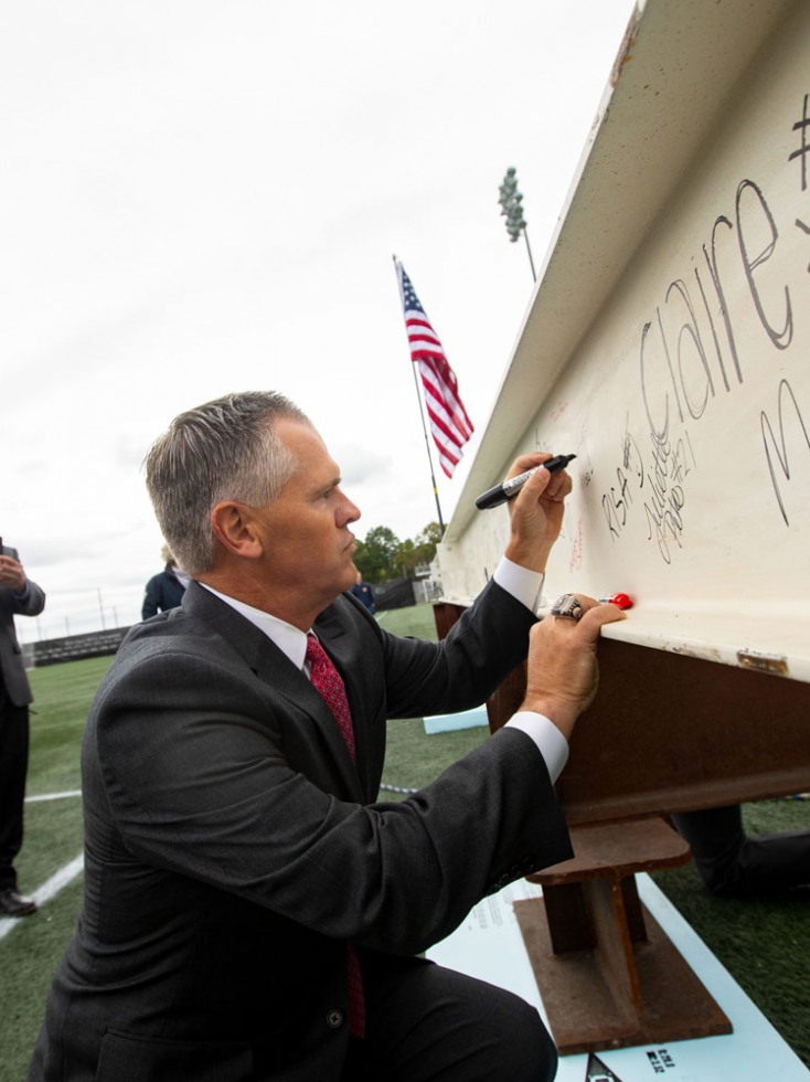 Jack Hayes signing steel beam at topping off ceremony