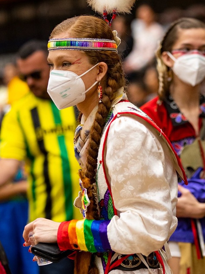 Sherente Harris wearing fancy shawl clothing and a mask