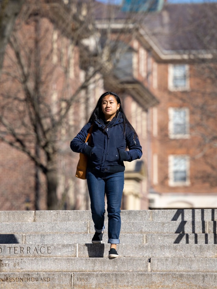 Ayla Kim walks down steps on campus.