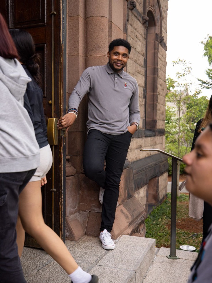 Jonathan Collins holding a door open