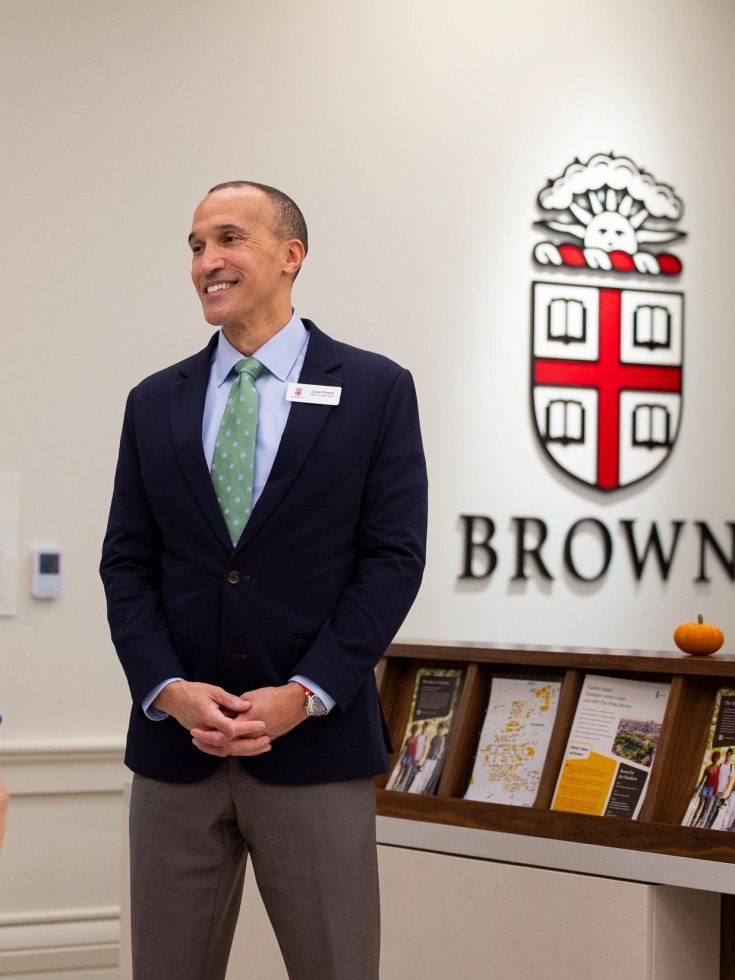 Logan Powell speaks with a visitor at the welcome center