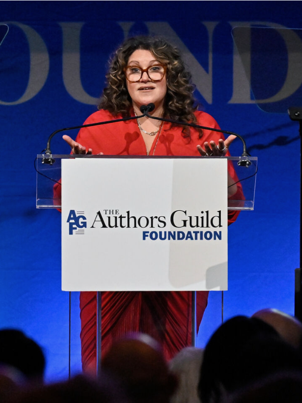 Xochitl Gonzalez speaks at a podium that says The Authors Guild Foundation