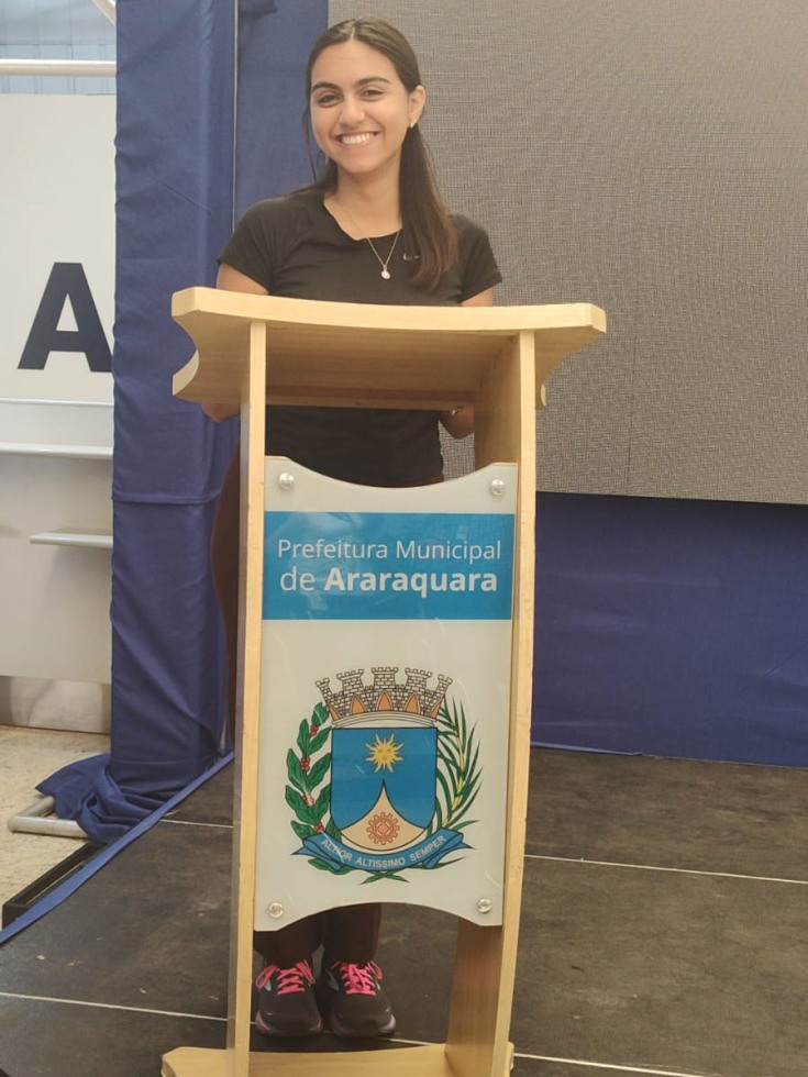 Michelle Alas Molina stands at lectern in Brazil