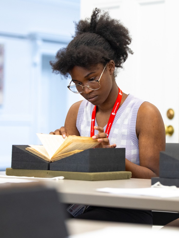 Caleia Worthen studies an object in the Hay's special collections
