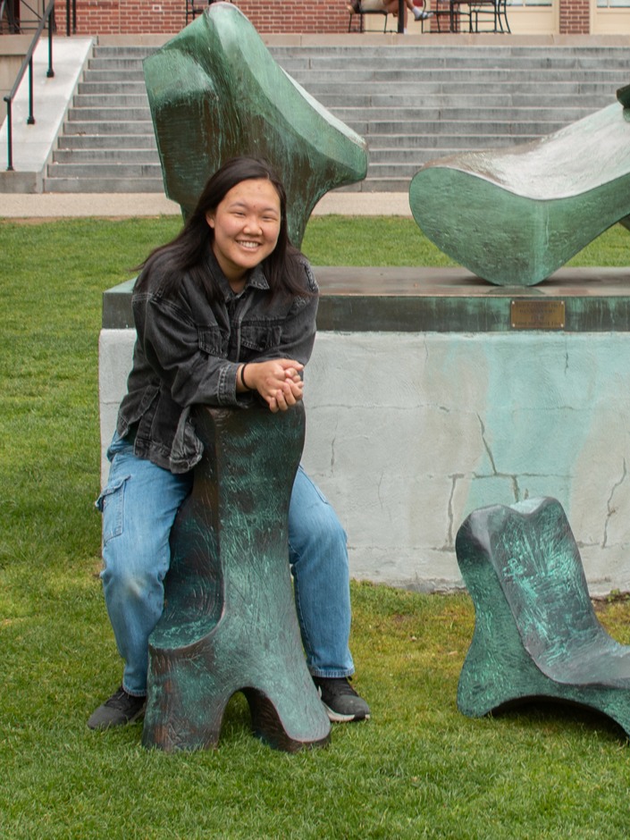 Naya sits on one of her chair sculptures