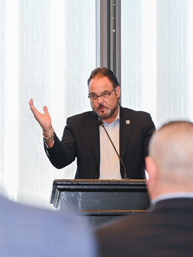 Michael Sabitoni speaks at a podium