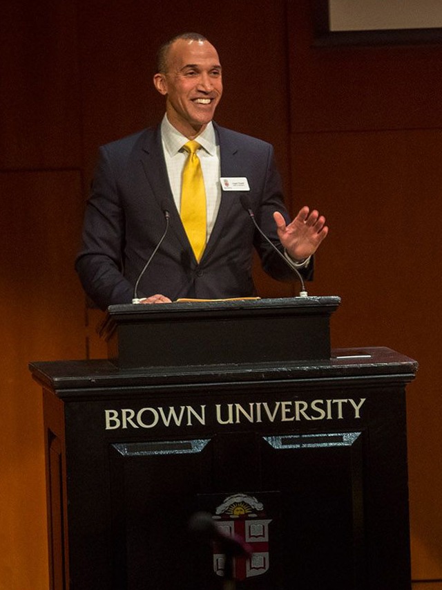 Logan Powell speaks at a podium