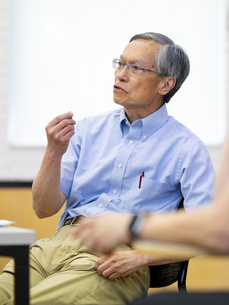 Brown professor Ken Wong speaks to a class of graduate students in a classroom. 