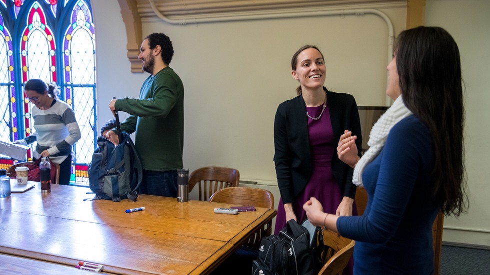 Professor Emily Oster chatting with students after class