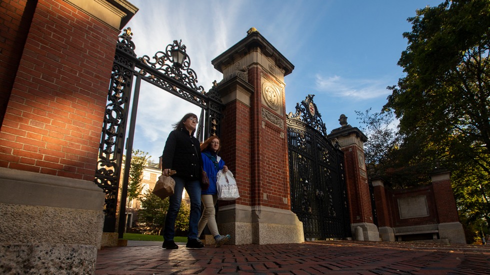 Mother and daughter walking through Van Wickle gates