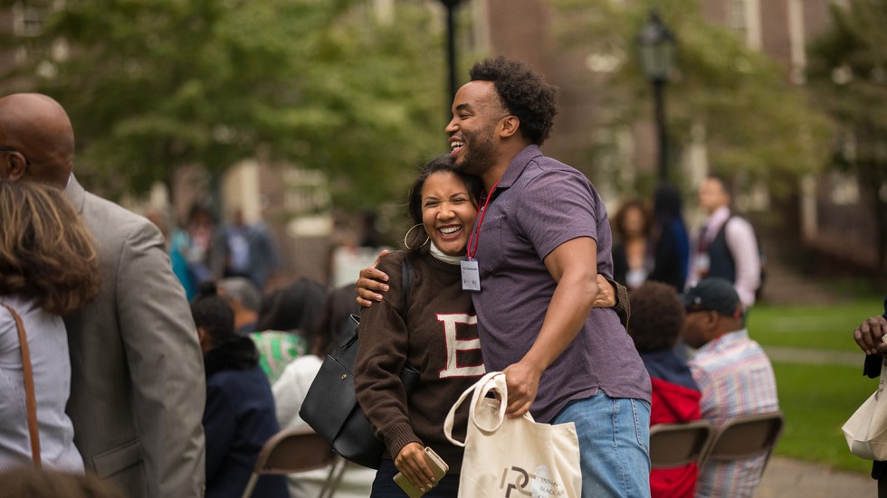 Woman and man embracing on campus