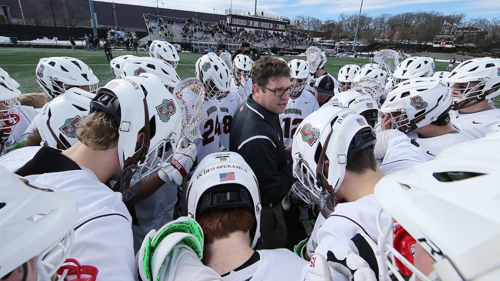 Men's lacrosse team huddle on field