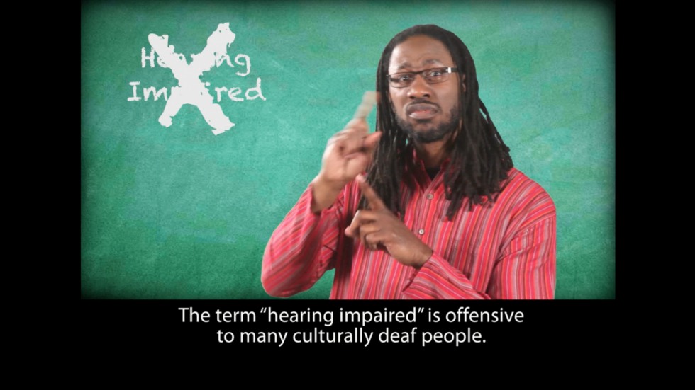 Video still with caption: The term hearing impaired is offensive to many culturally deaf people.