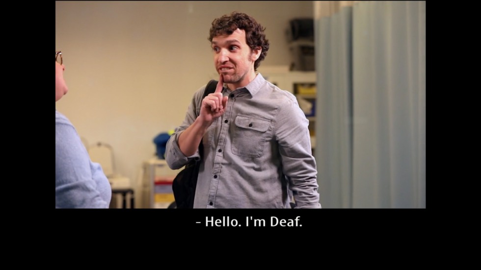 Video still with caption: Hello, I'm Deaf.