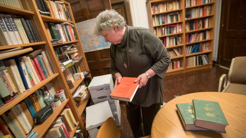 Levy with books in library