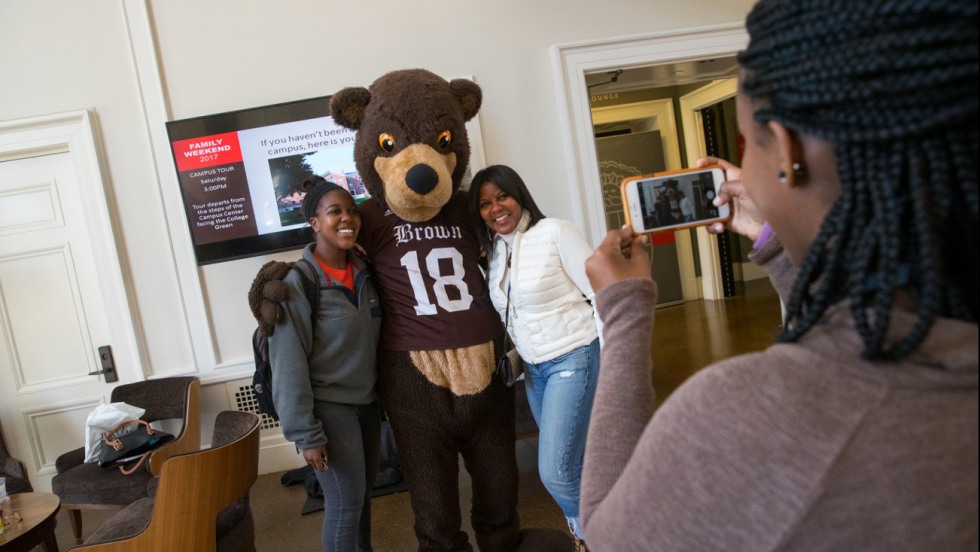 Maya and Donna Coaxum posing with Bruno during Family Weekend