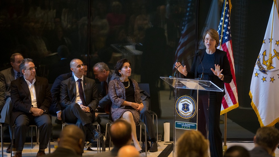 Paxson speaking, while Raimondo looks on