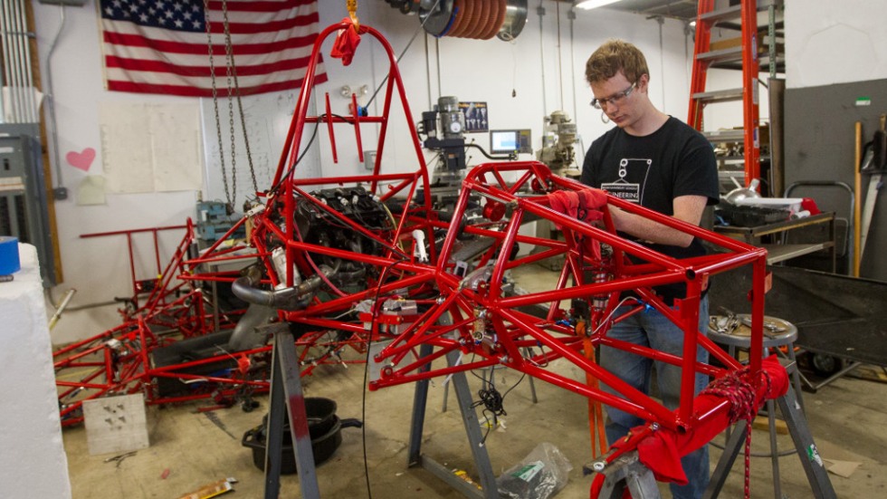 Brennan MacInnes works on the suspension system