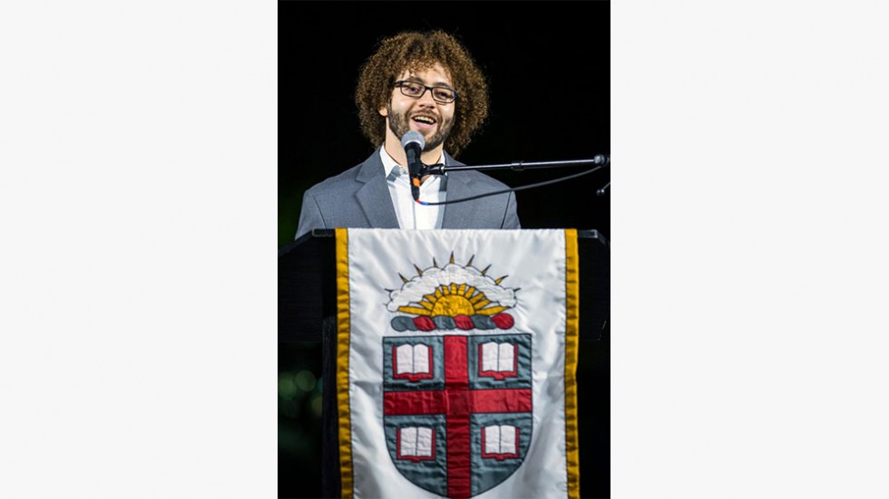 Joshua Segui speaking from a podium