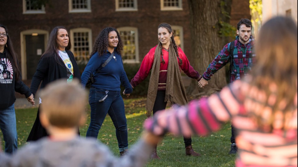 People holding hands in a circle.