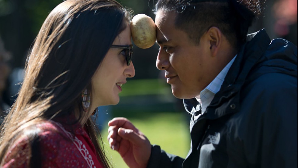 Two people with a potato between them.