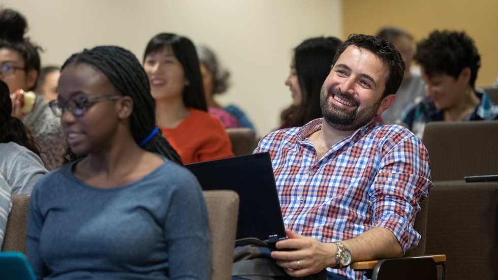 Dr. Khaled Almilaji smiling in class