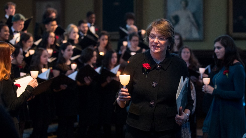 President Paxson holding a lit candle