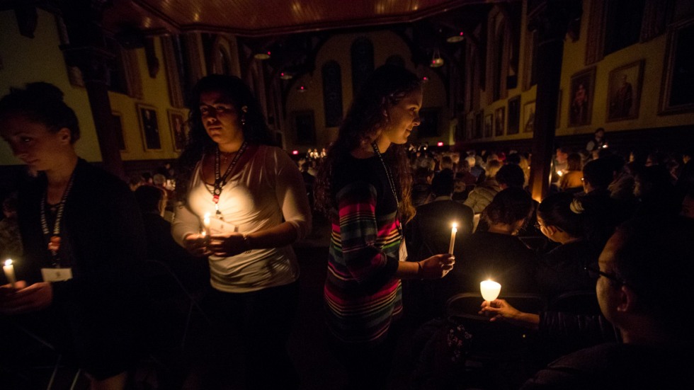 Margaret Barton and others lighting their candles