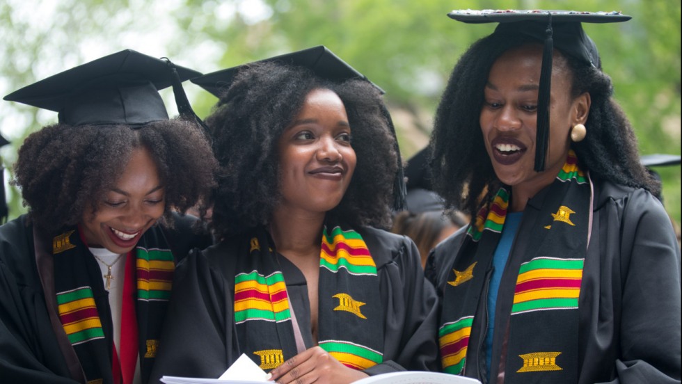 Ashlee Thomas, Brittany Hodges and Gloria Essien in grad caps and robes