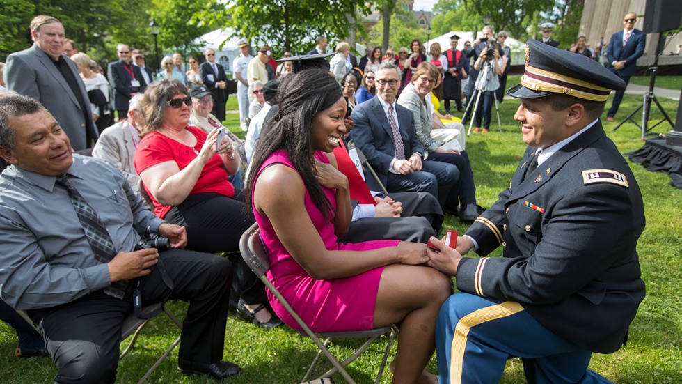 Aranda kneeling, proposing to Uzoamaka Okoro