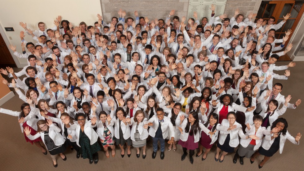 Aerial shot of all first-year med students looking up and waving