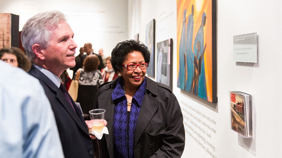 Ruth Simmons and Kevin McLaughlin at exhibit admiring a painting