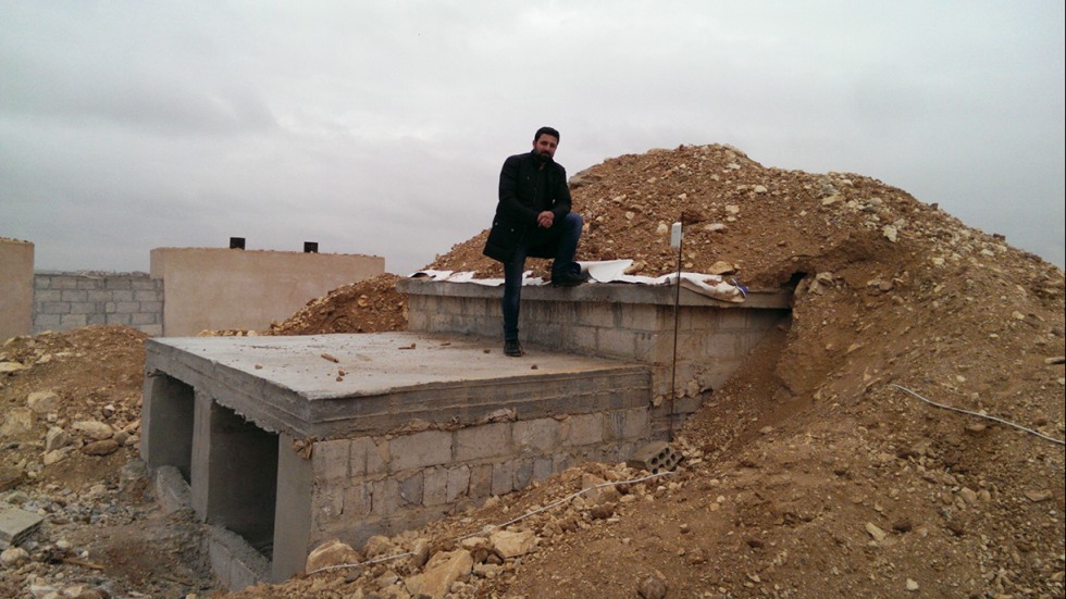 Dr. Khaled Almilaji standing on roof of underground building