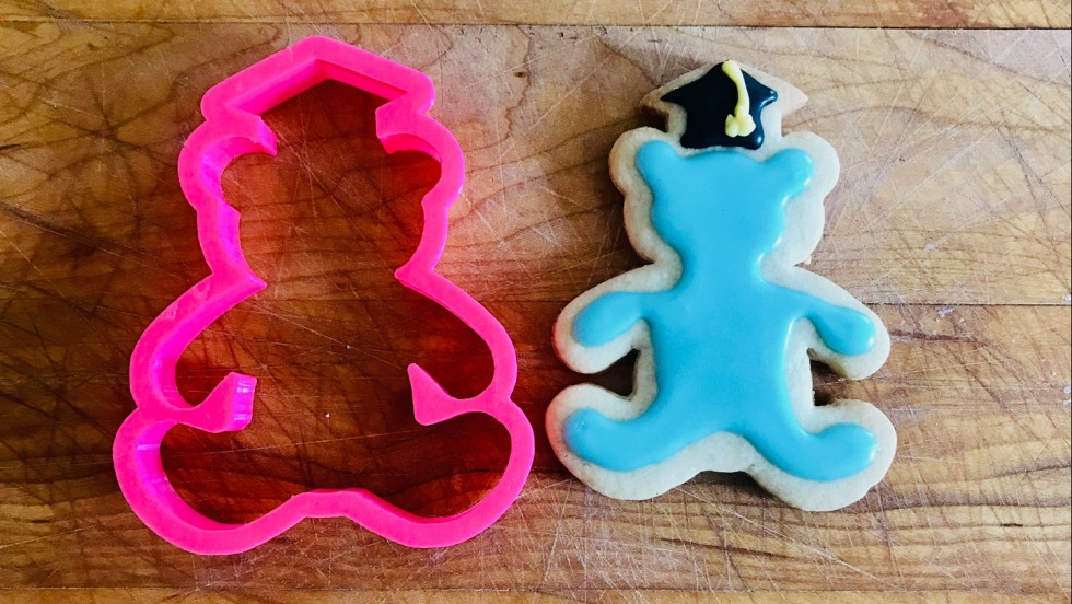 Blueno shaped cookie cutter next to an iced cookie