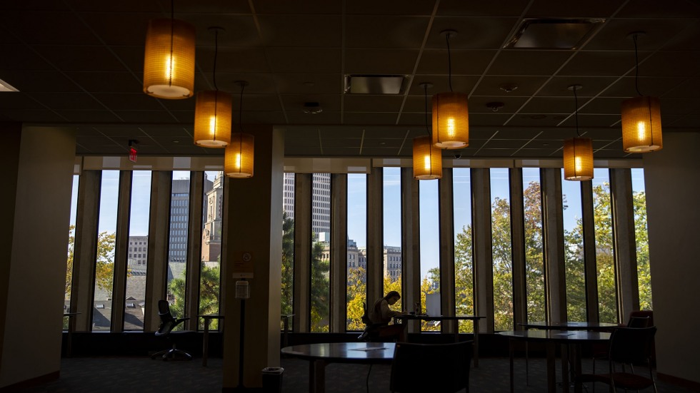 A student studies in a socially-distanced cubicles at the Rockefeller Library at Brown University