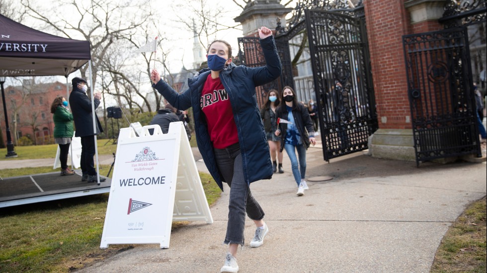 Student walking through Van Wickle Gates