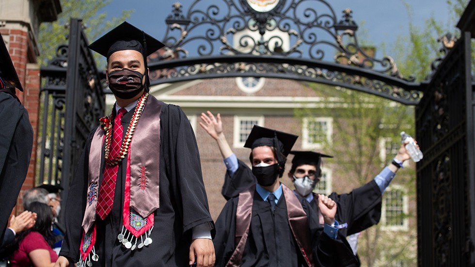 Graduates walking through the Van Wickle Gates