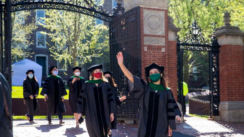 Medical School Graduates walking through the Van Wickle Gates