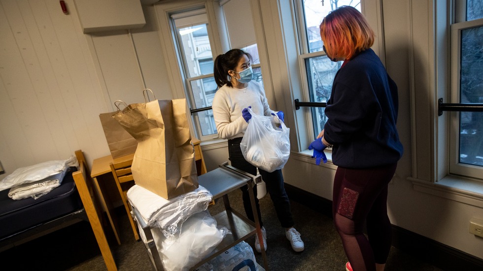 Student EMS staff prepare a room for a student in quarantine and isolation