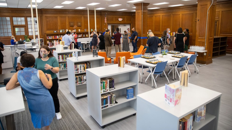 bookshelves, tables and chairs in a library