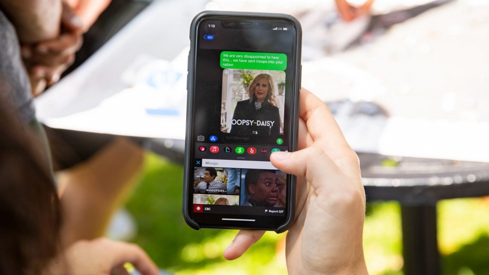 person text messaging someone a "whoops" gif