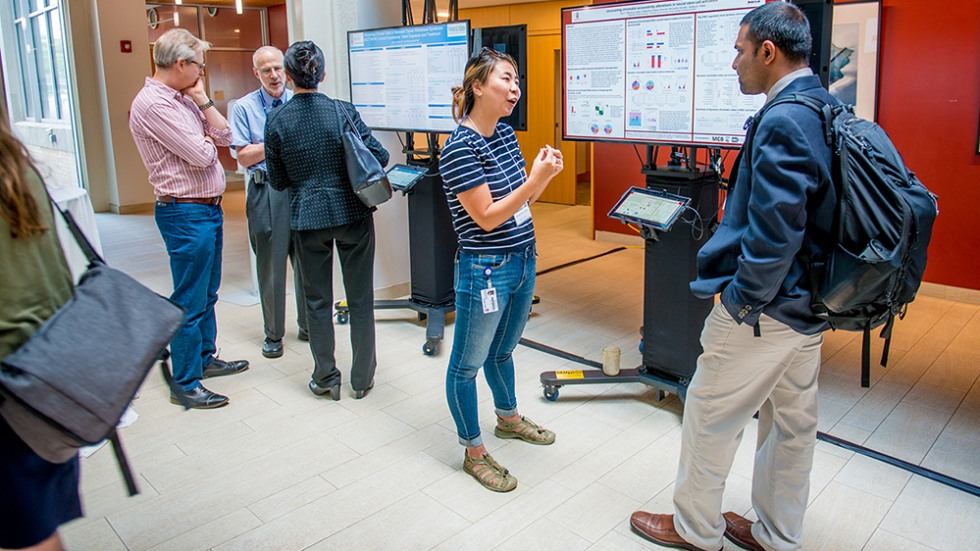 Researchers discussing their presentations