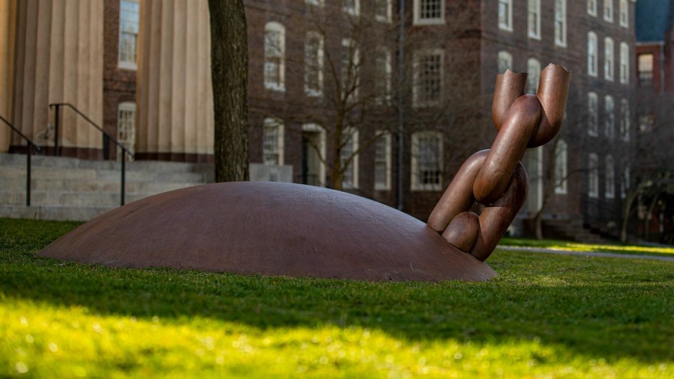 ball and broken chain sculpture on a green lawn 